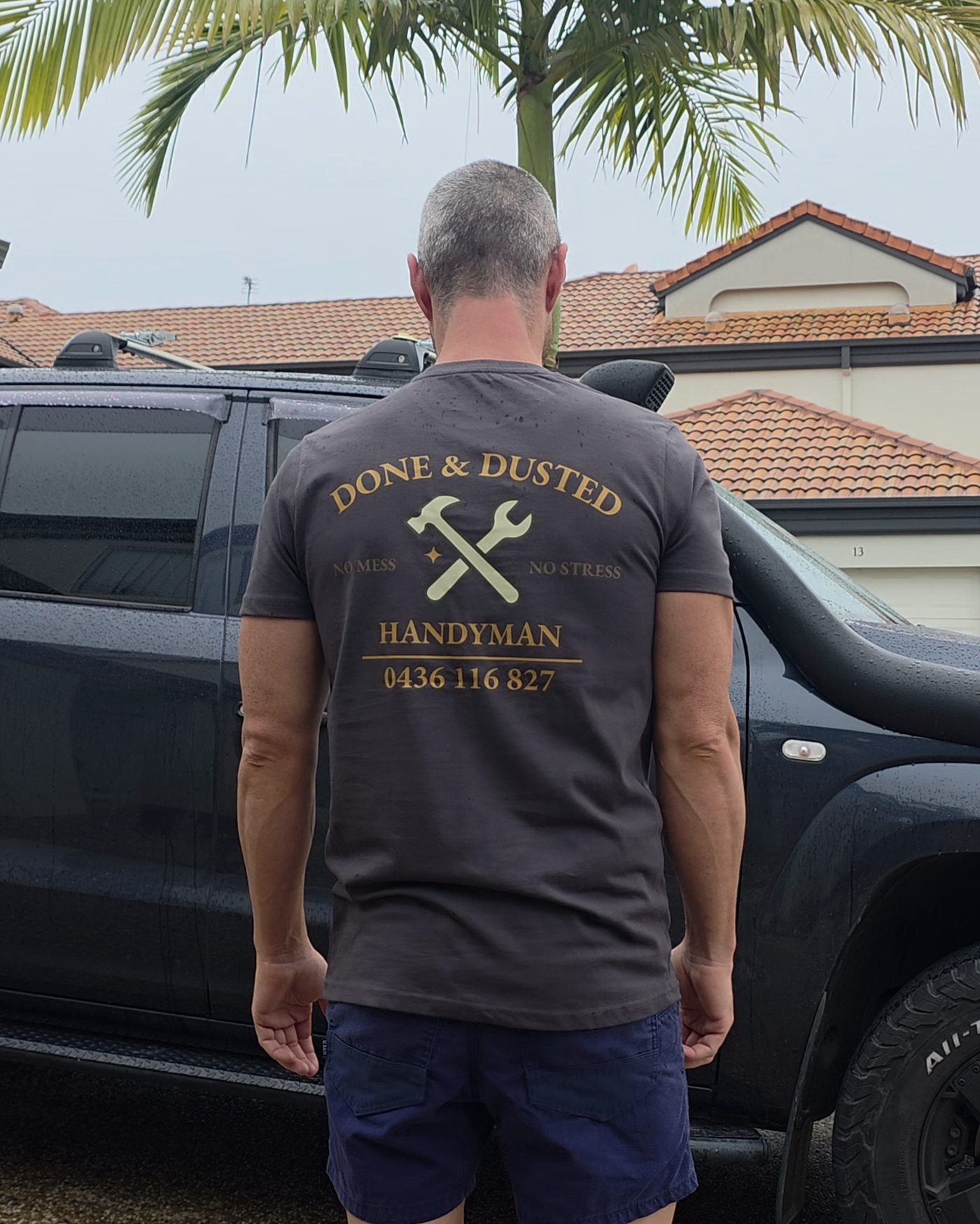 Done & Dusted Works branded uniform — professional pressure cleaning service on the Gold Coast
